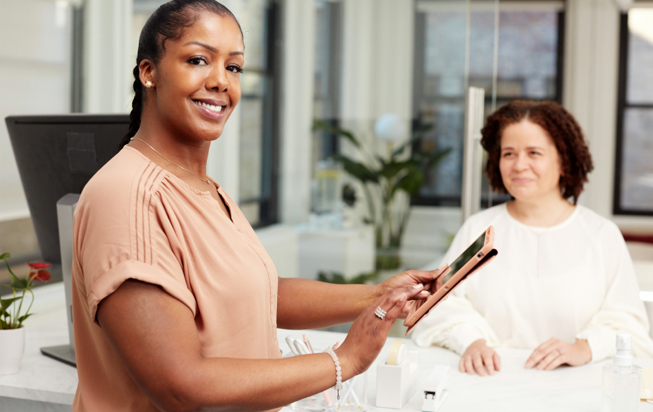 Two women interacting in a bright office